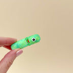 Close-up of the cyclops eye and textured details on the Picklops fidget toy.