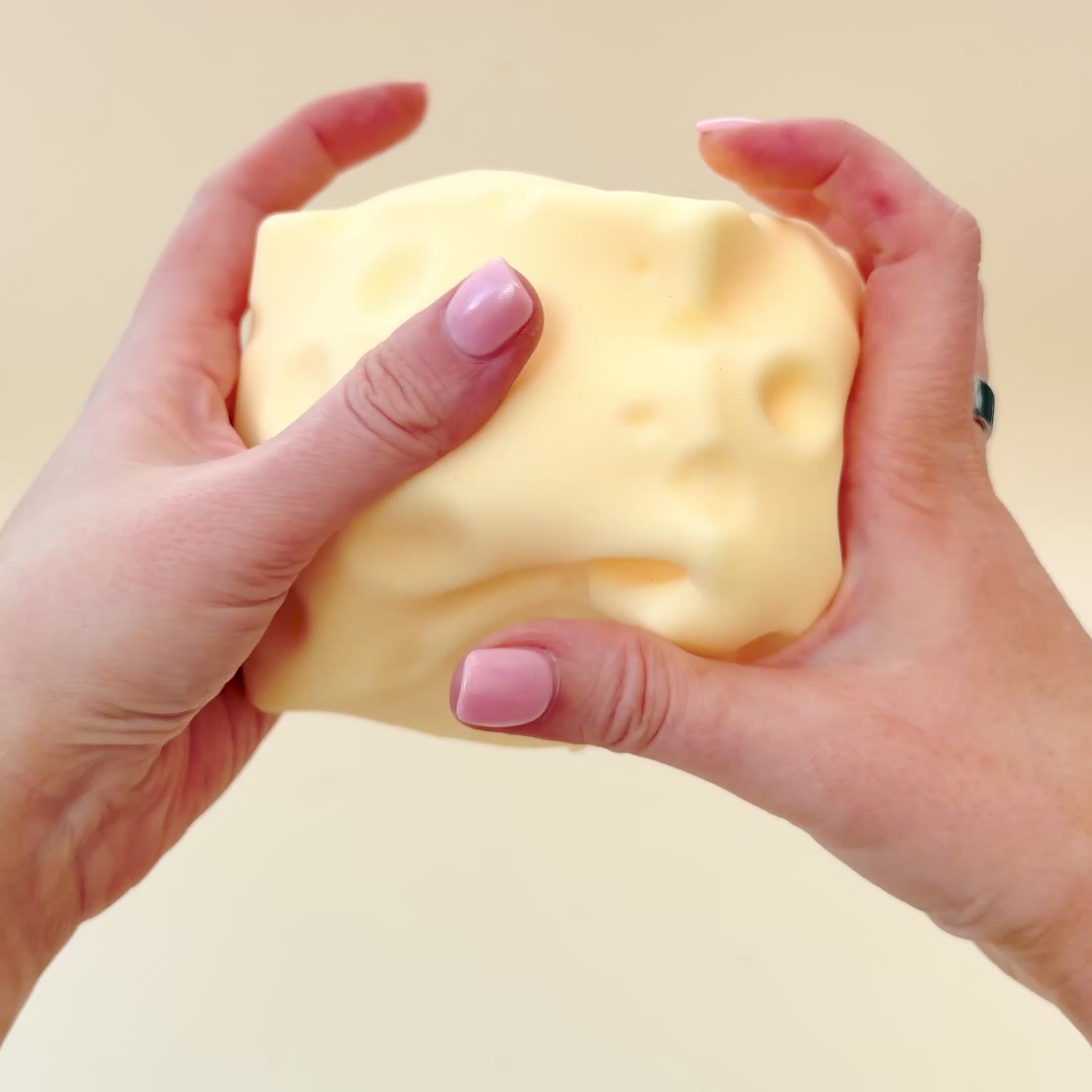 Soft-touch cheese squishy with a smooth flocked finish and slow squish for soothing sensory input.