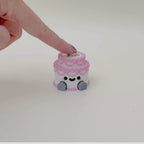 Handheld sensory clicker with a detailed layered design, dangling legs, and optional quieter click feel.
