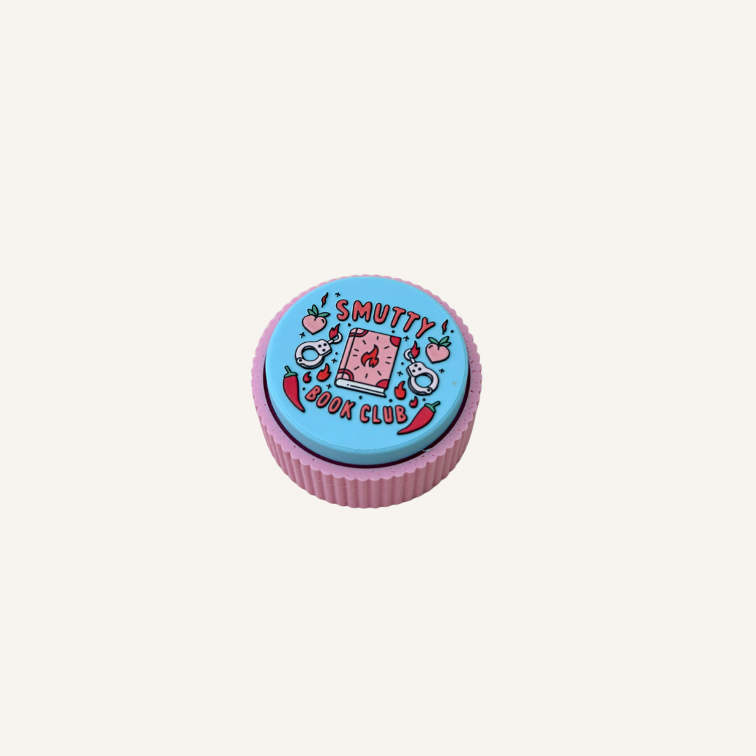 Palm-sized Smutty Book Club Clicker with colourful book, handcuff, chilli and peach themed artwork.