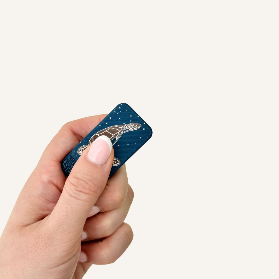 Textured magnetic fidget pair with raised surface details for tactile input, gripping, sliding and twisting.