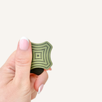 Textured magnetic sensory fidget with raised concentric ridges for finger tracing, gripping, sliding and twisting.
